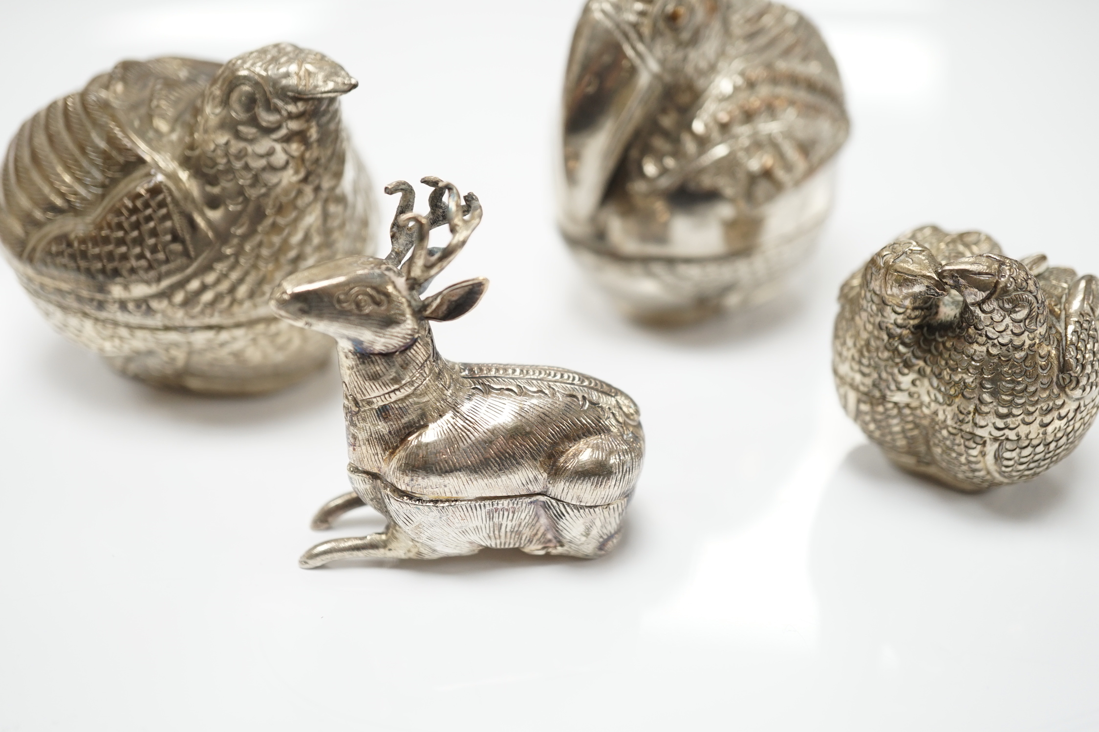 Four South East Asian white metal small ‘animal’ boxes. Largest 6cm